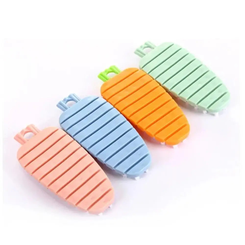 Flexible silicone vegetable and fruit cleaning brush in pastel peach blue orange and mint green carrot shapes