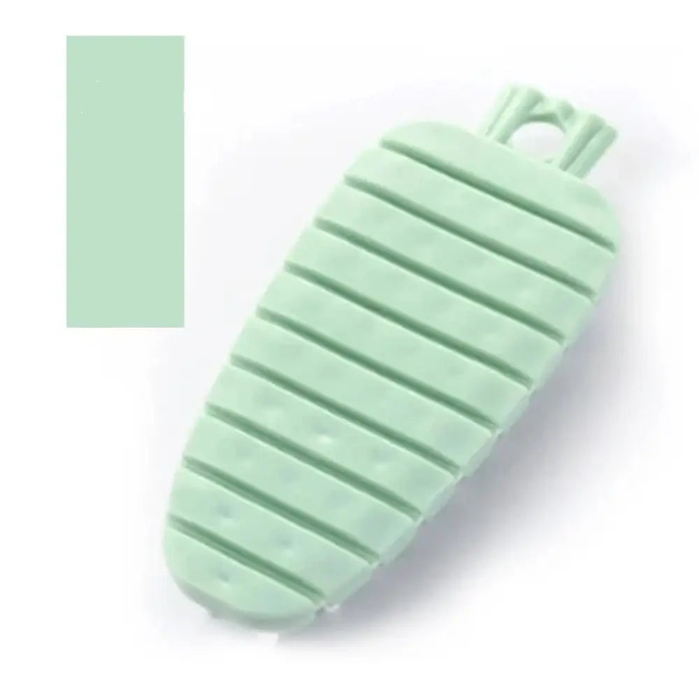 A mint green flexible silicone carrot-shaped bath sponge with ribbed texture and looped handle for cleaning use