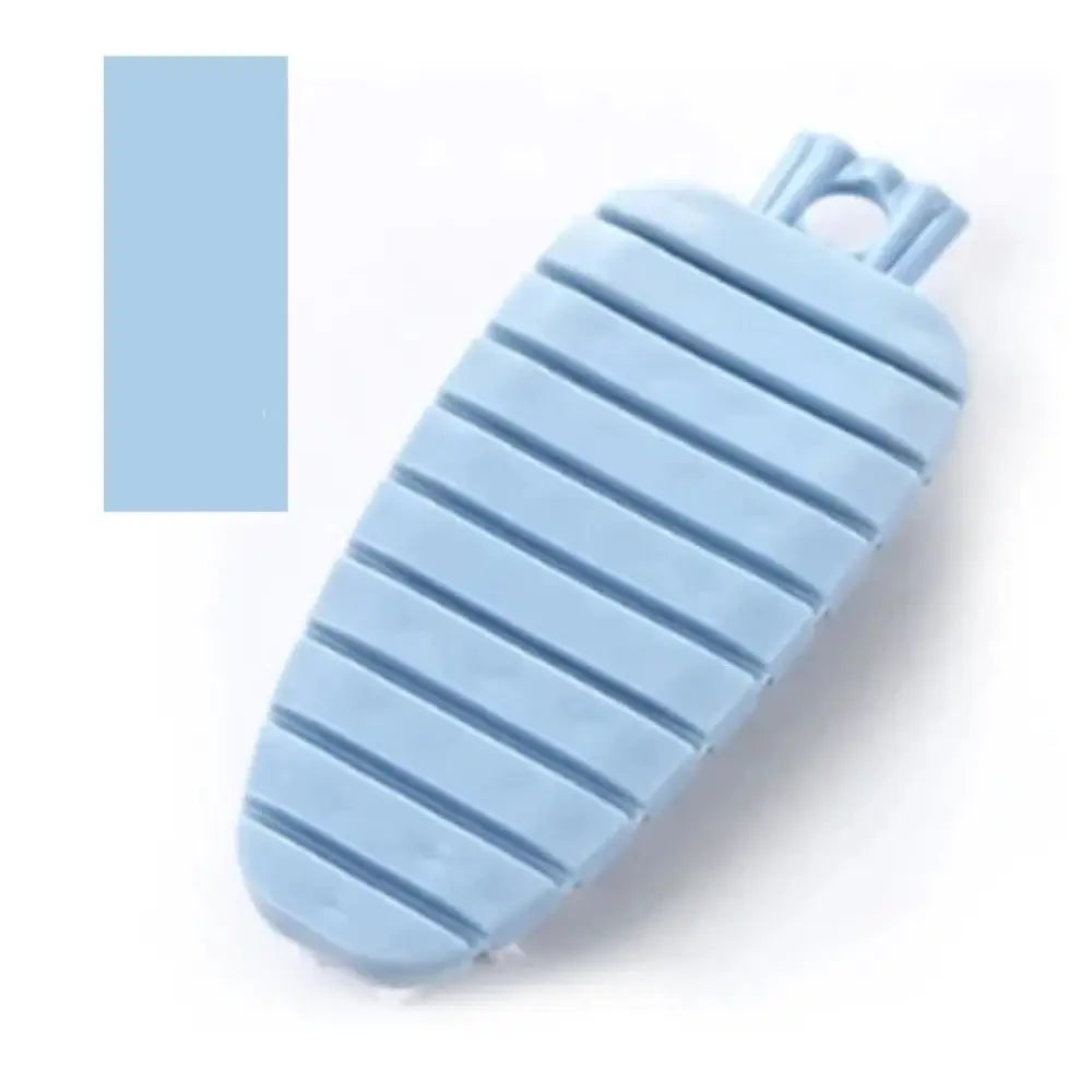 Light blue flexible silicone vegetable and fruit cleaning brush shaped like a carrot with ridged texture and hanging loop