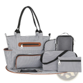 Multifunctional 8 piece striped diaper bag set in black and white with brown leather accents and multiple accessories