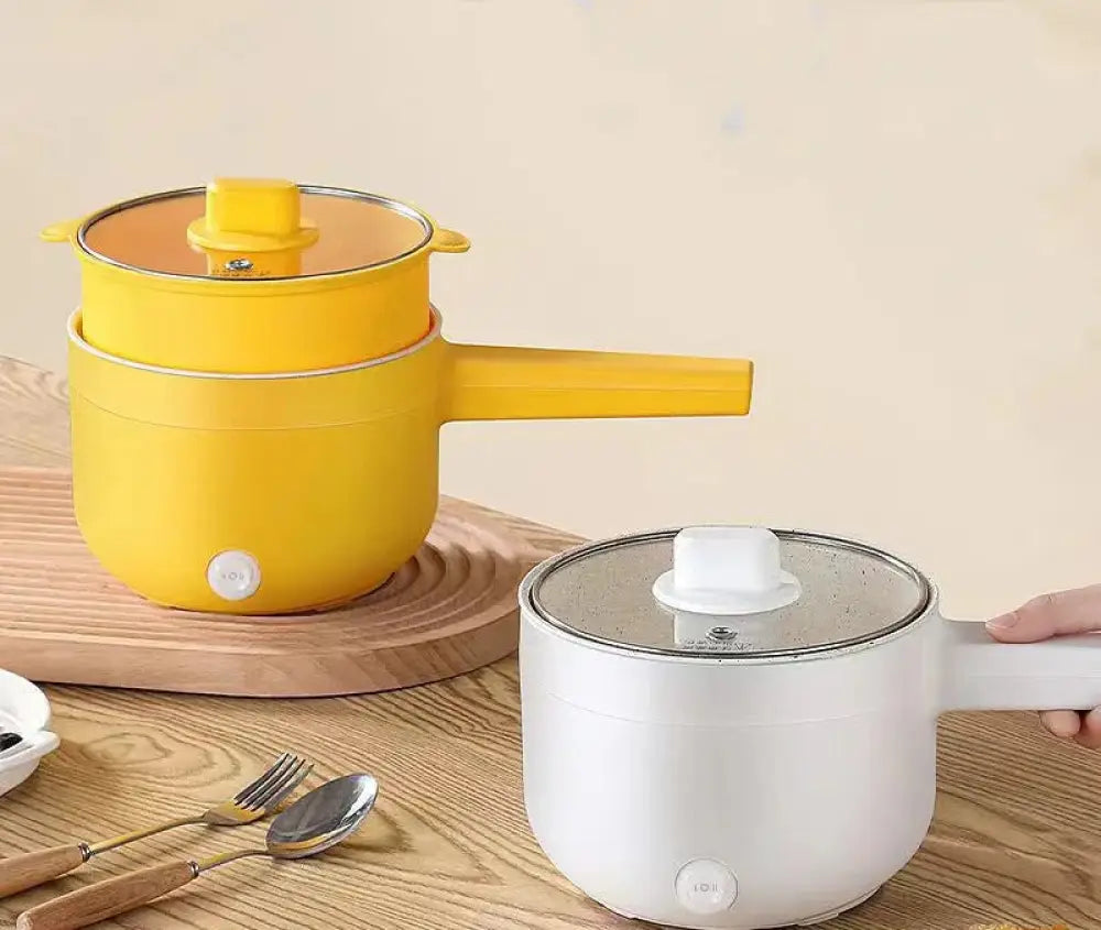 Yellow electric mini multi cooker with glass lid and handle featuring a sleek modern design for hot pot and frying pan use