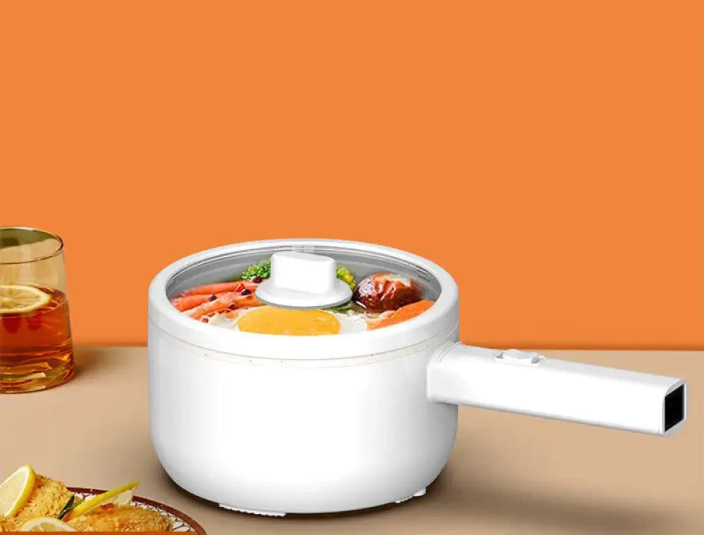 White electric mini multi cooker hot pot and frying pan with transparent lid showing colorful vegetables and egg inside