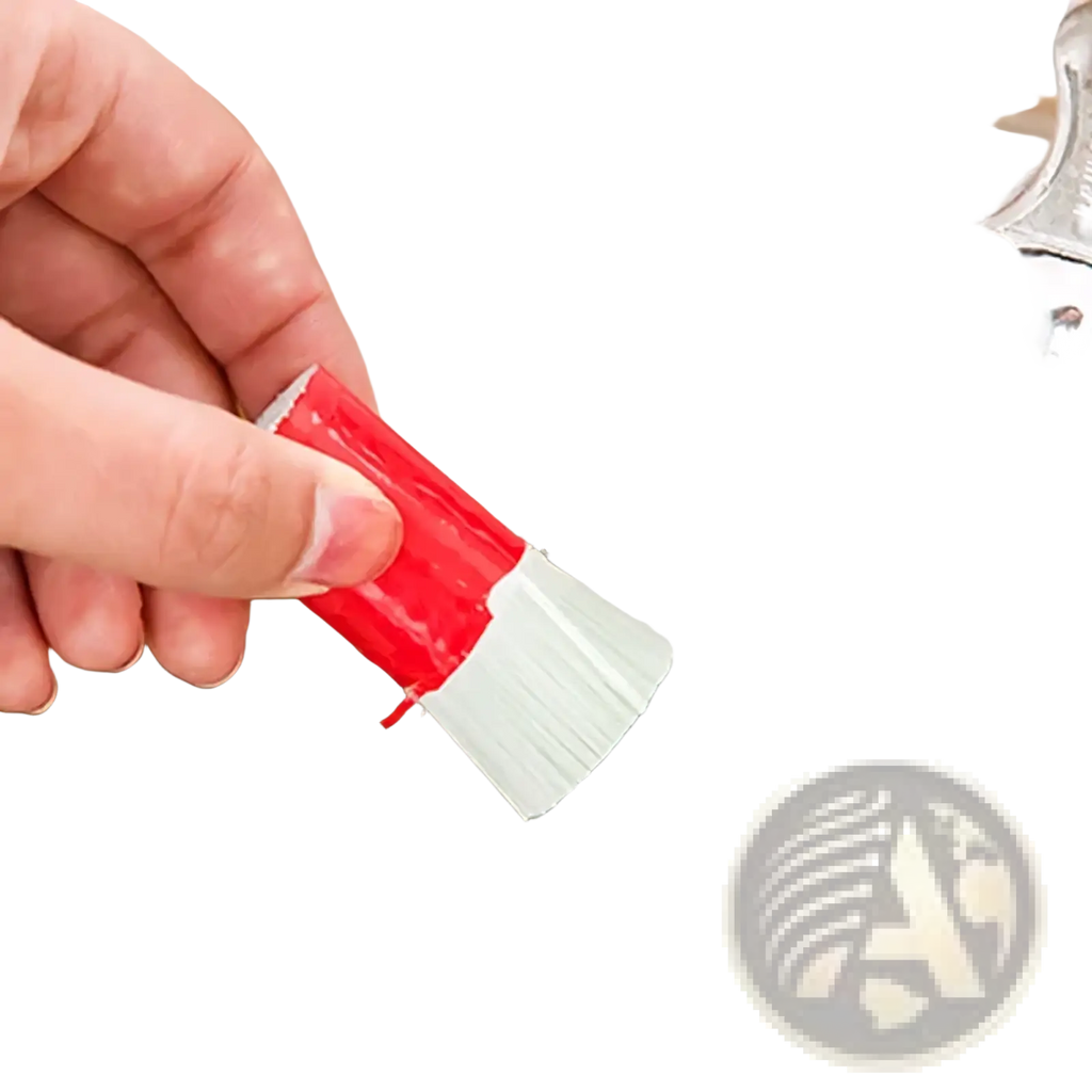 Multifunctional kitchen scrub brush with red handle and white bristles cleaning a stainless steel sink