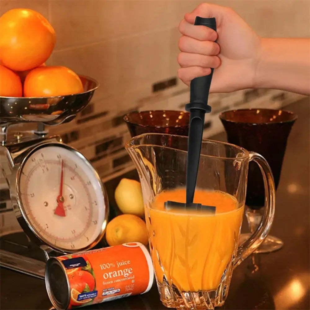 Black heat resistant nylon handheld citrus juicer with flat rectangular blade for squeezing oranges into glass pitcher