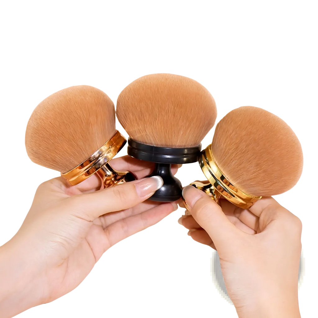 Three tan plush multifunctional oversized soft powder makeup brushes with gold and black handles held by two hands