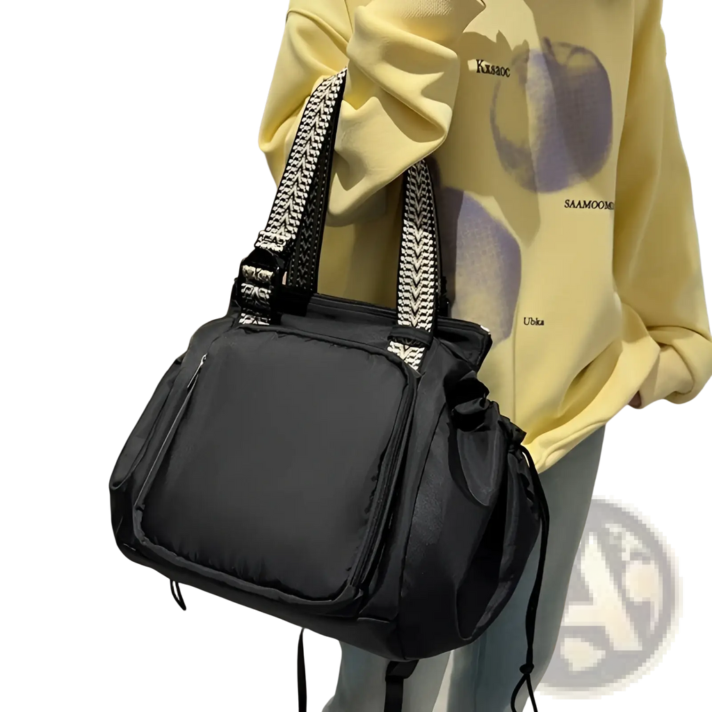Black multifunctional waterproof nylon shoulder bag with patterned woven straps for fashion tote and backpack use
