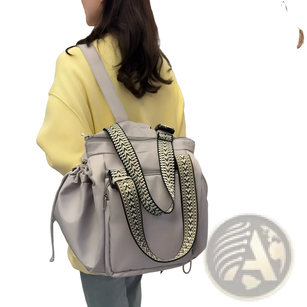 Gray nylon multifunctional waterproof tote and backpack with black and white geometric patterned shoulder straps