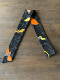 Black fabric scarf with orange and yellow bats flying against starry night sky for hair and bow tie use