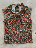 Vintage mushroom print sleeveless bow top in black featuring a vibrant colorful mushroom pattern in red orange and pink