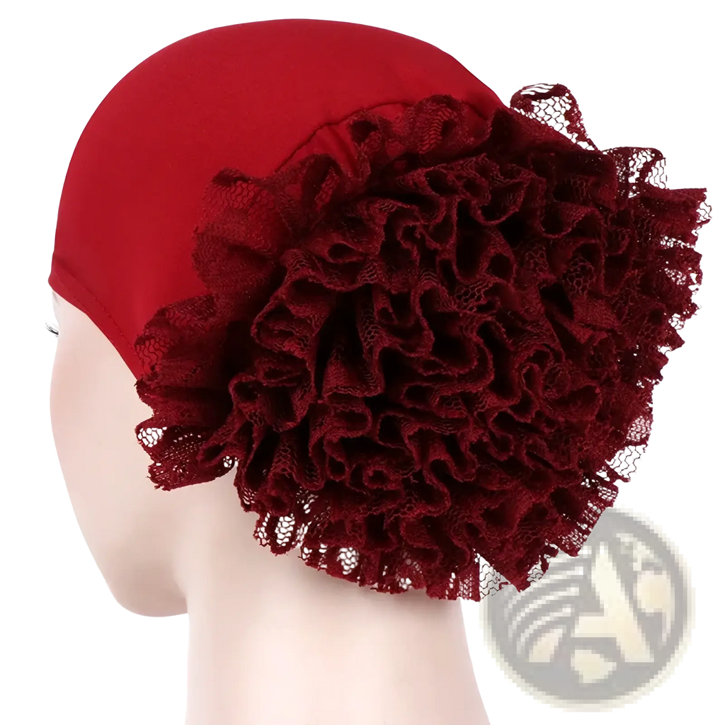 A smooth red muslim hijab cap featuring a rich burgundy lace flower embellishment on the side