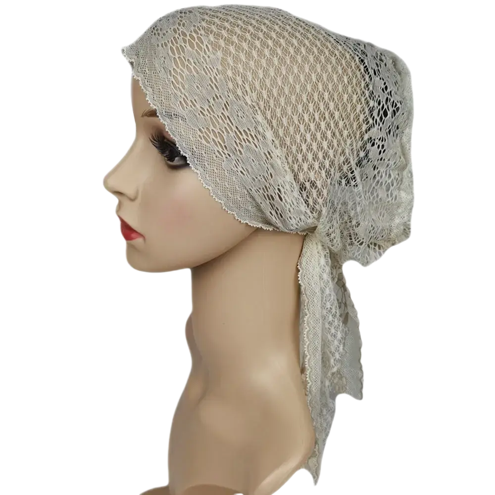 A delicate off-white Muslim turban lace cap with breathable mesh texture and subtle floral patterns for chemo headwear