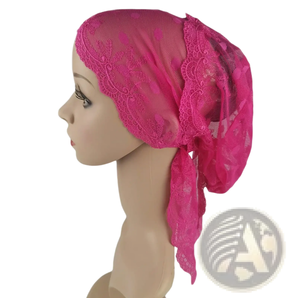 A vibrant fuchsia muslim turban lace cap with floral patterns and sheer mesh tied elegantly for chemo headwear
