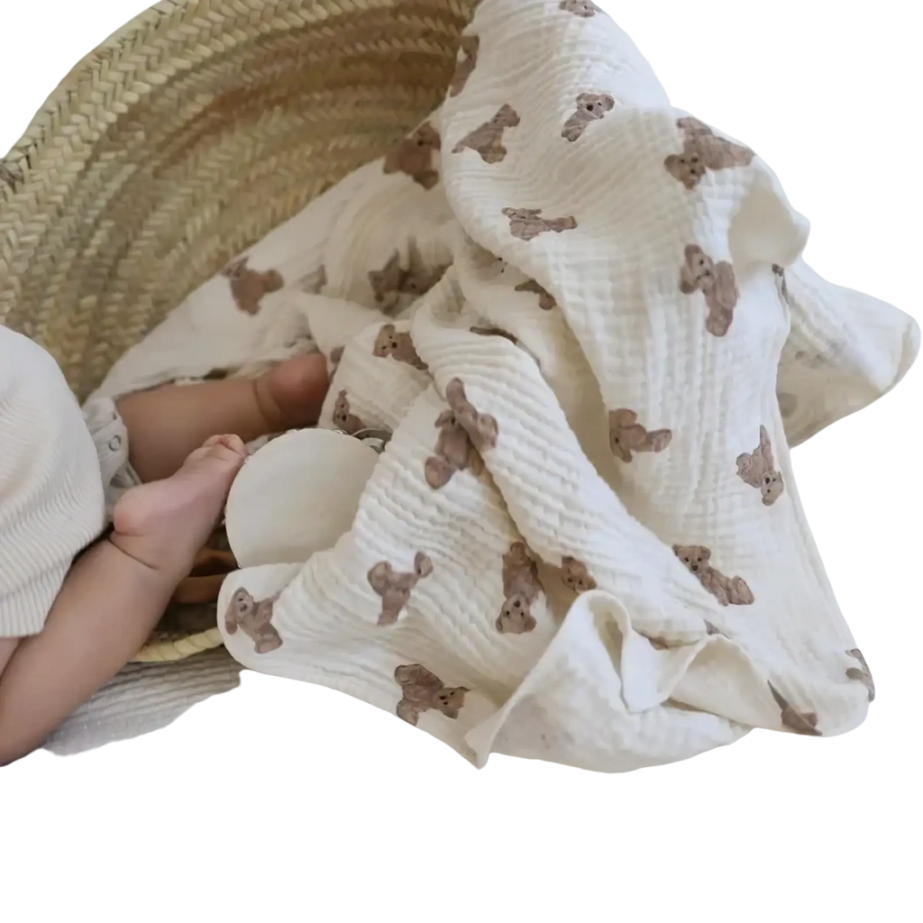 Muslin bear print baby bath towel and swaddle blanket in soft off-white with waffle texture and brown teddy bear prints