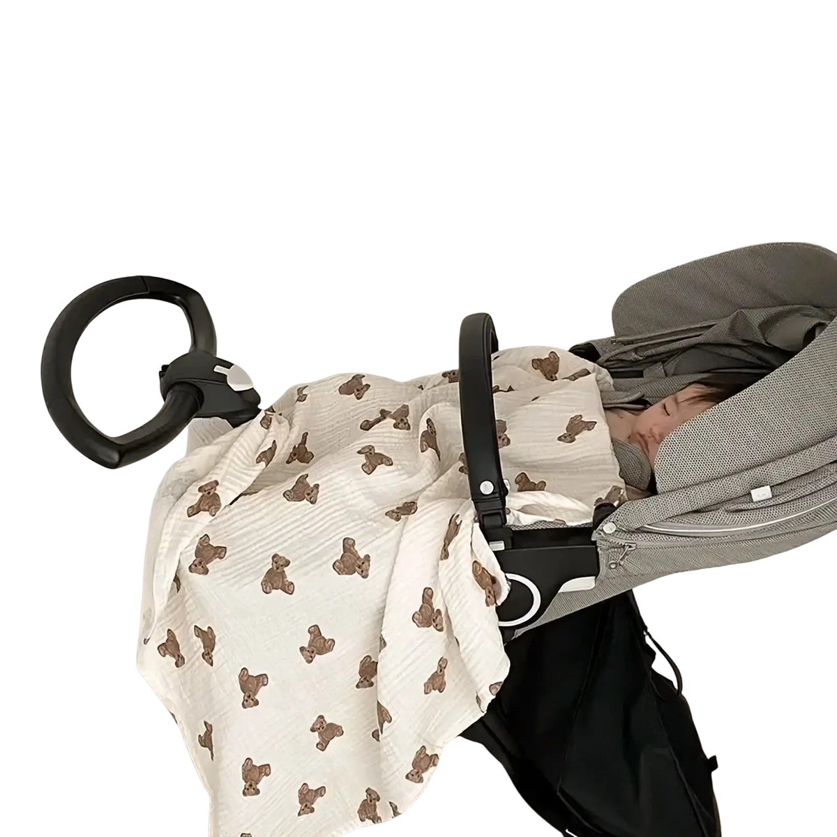A soft off-white muslin bear print baby bath towel and swaddle blanket draped over a stroller