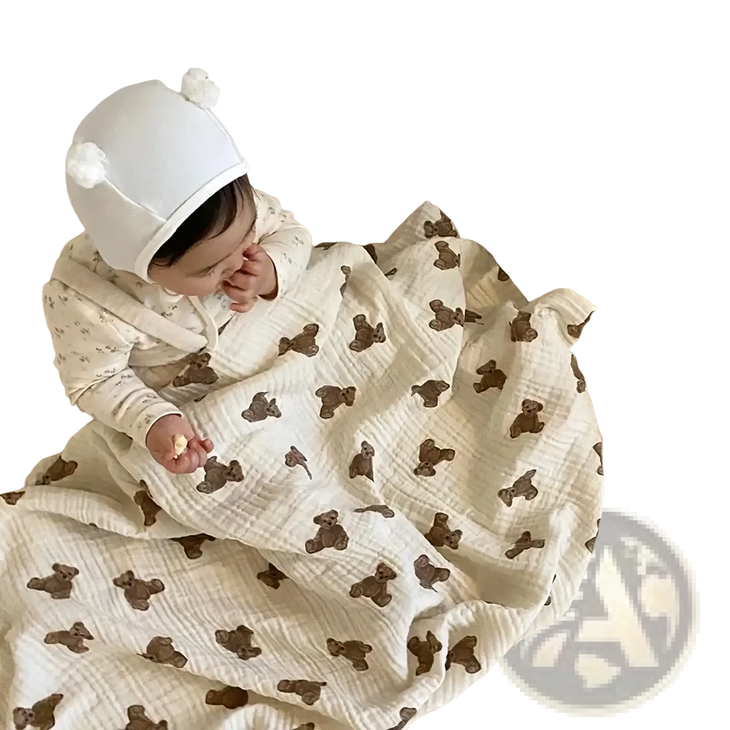 Muslin bear print baby bath towel and swaddle blanket in soft off-white cotton with brown teddy bear pattern
