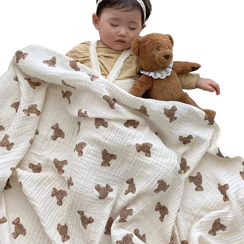 Muslin bear print baby bath towel and swaddle blanket in off-white soft muslin with textured weave and brown teddy bears