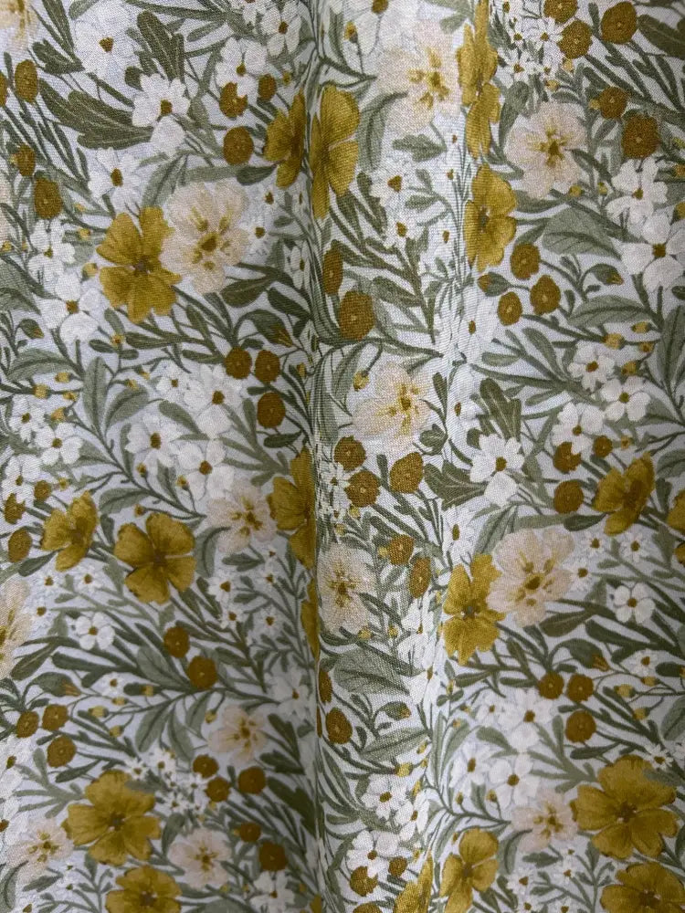 Vintage mustard floral cotton midi dress with pockets featuring delicate white fabric and floral pattern with yellow and green blossoms