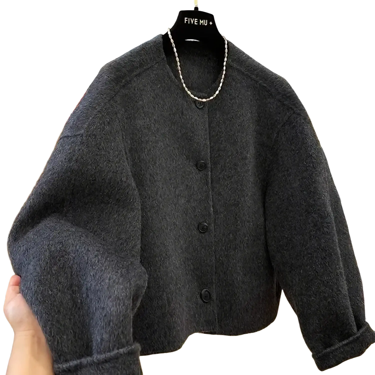 Dark gray fluffy woolen cardigan with black buttons and round neckline complementing mustard yellow wool blend coat