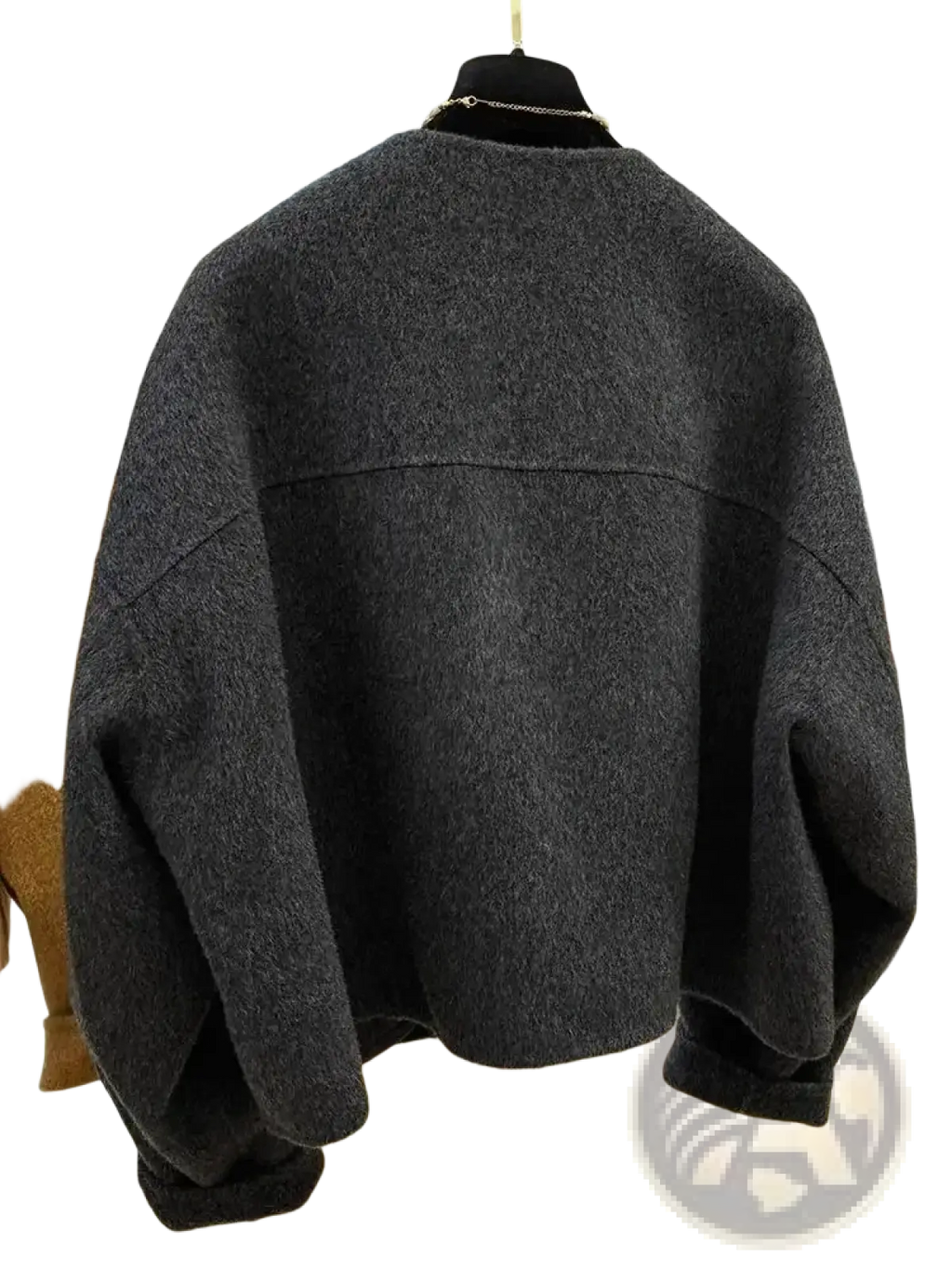 Dark gray oversized knit sweater with relaxed fit and ribbed cuffs paired with mustard yellow wool blend short coat women