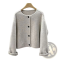 A soft light gray knit cardigan with black buttons and rolled cuffs for women complementing a mustard yellow wool blend short coat