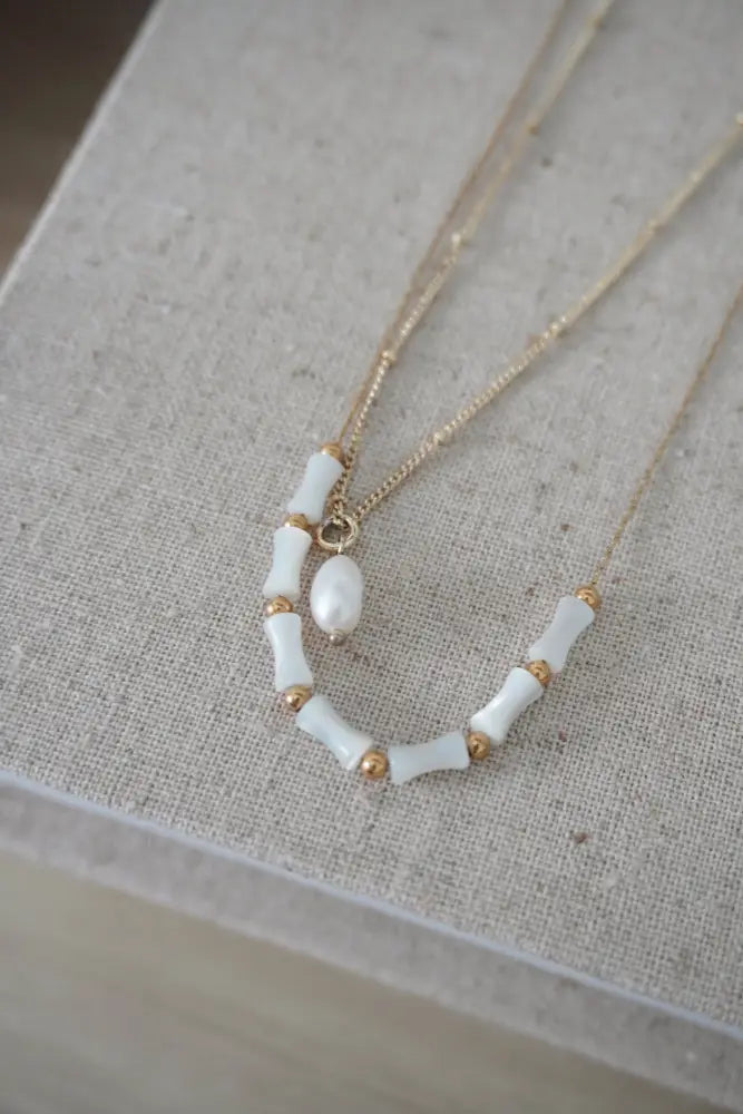 Mykonos white ceramic and gold beaded chain necklace with curved design segmented beads and central pearl accent