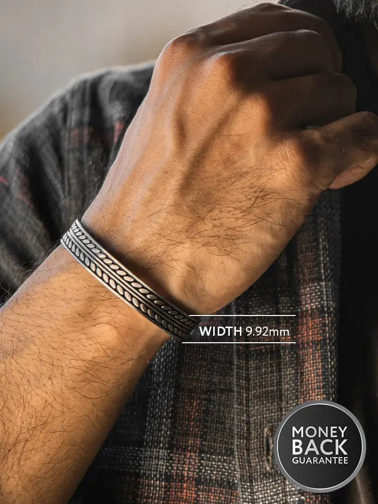 Silver-toned native feather textured 316l stainless steel cuff bracelet with intricate braided and embossed pattern