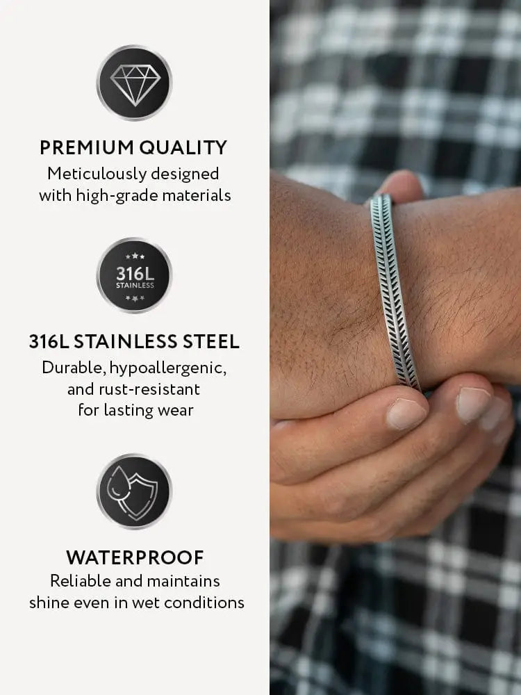 A sleek silver-toned native feather textured 316L stainless steel cuff bracelet worn on a wrist