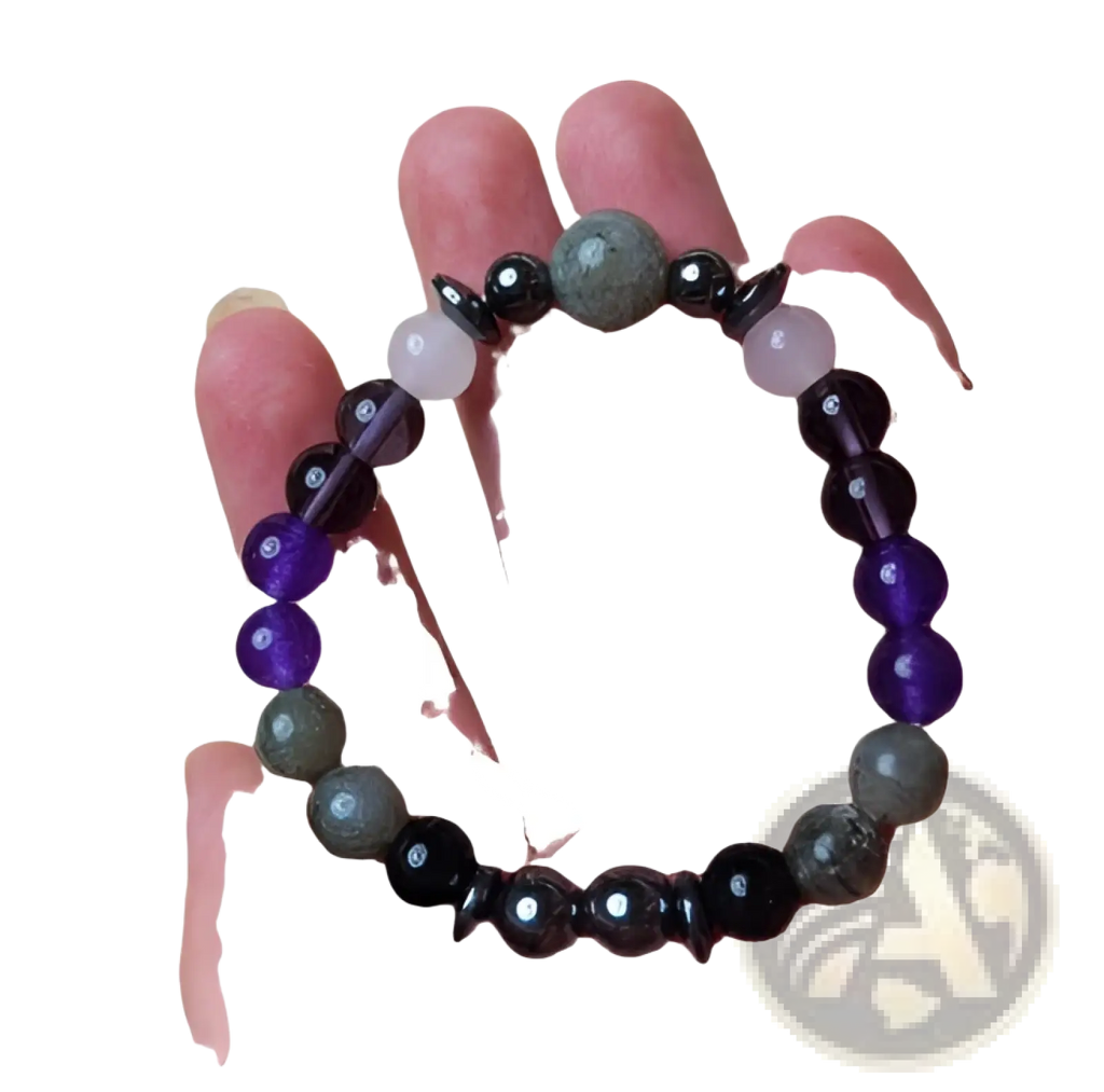 A handcrafted natural amethyst and magnetic stone beaded unisex bracelet with polished purple, black, and gray beads