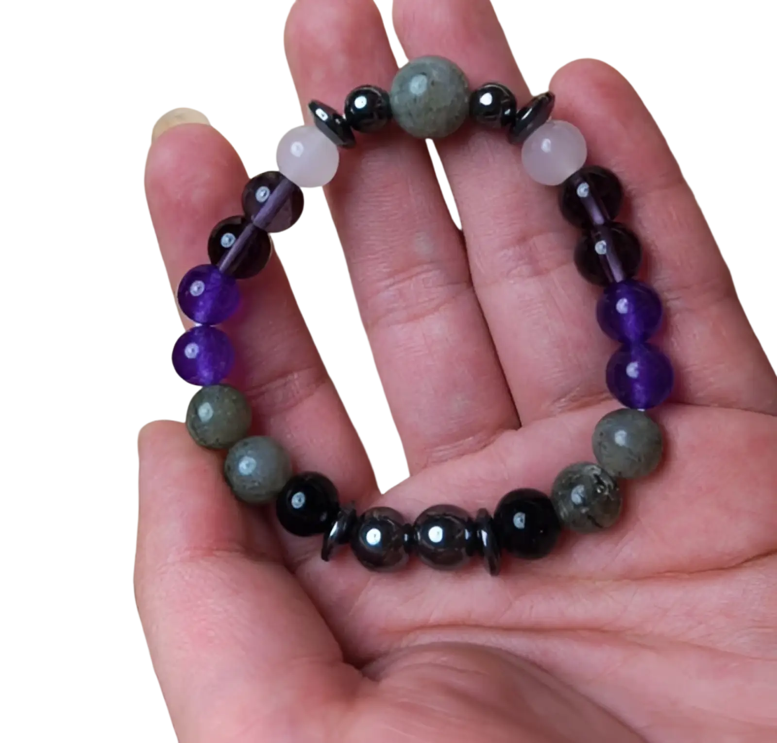 A hand holds a natural amethyst and magnetic stone unisex bracelet with purple amethyst, pink quartz, moss agate, and obsidian beads