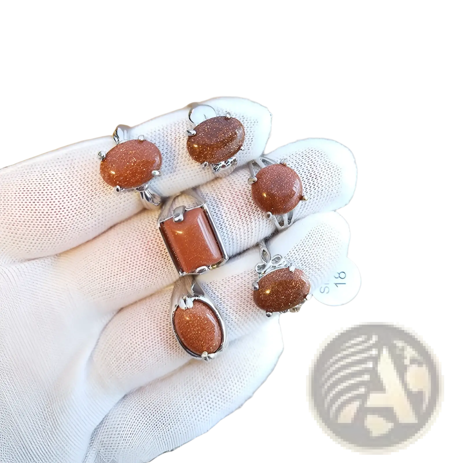 A set of four elegant silver tone statement rings featuring oval and rectangular orange gold sandstone stones