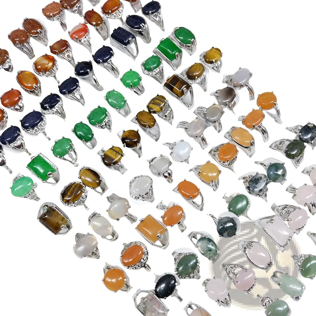 A collection of silver tone statement rings with oval rectangular and round natural colored gemstones