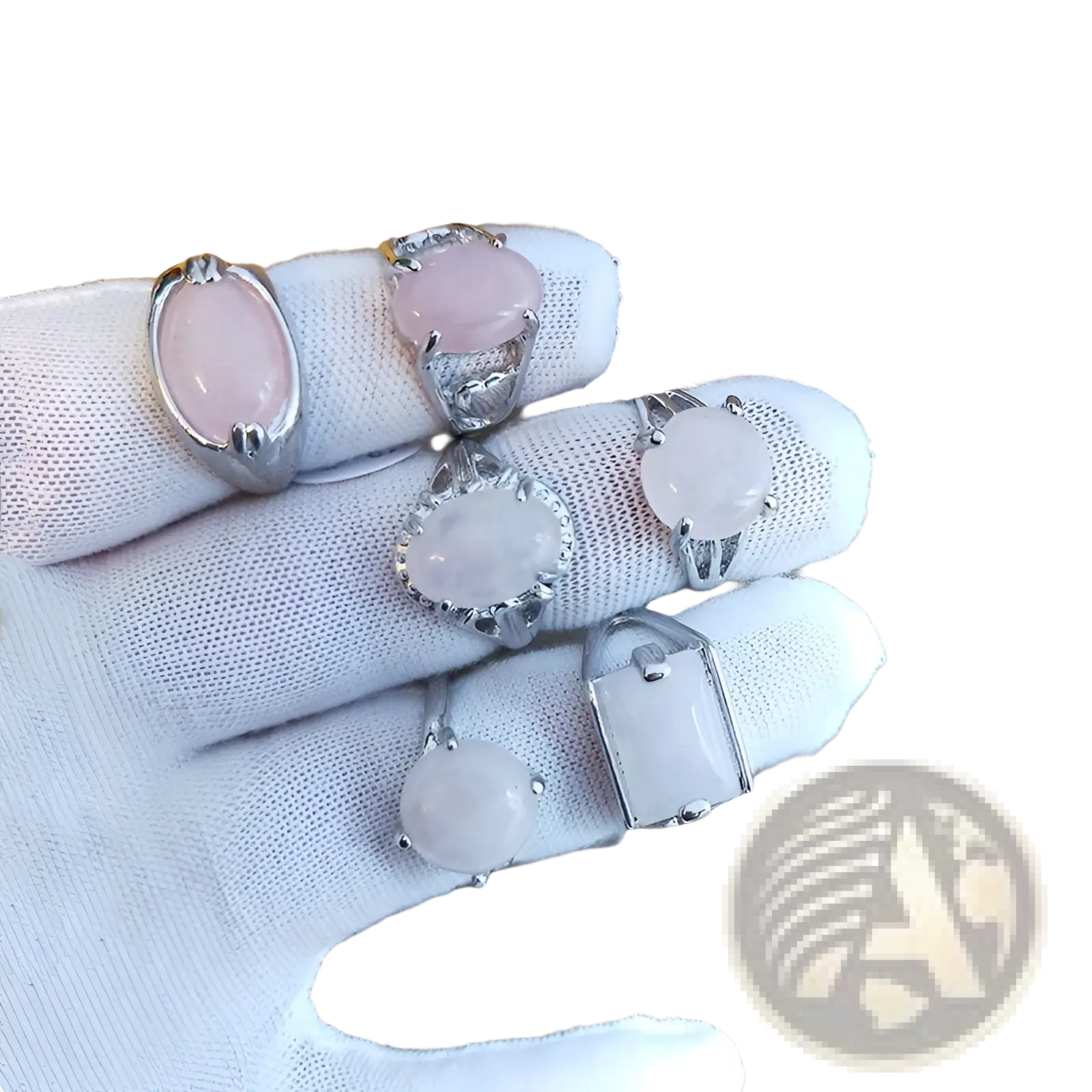 A collection of natural rose quartz silver tone statement rings featuring oval and round shaped gemstones