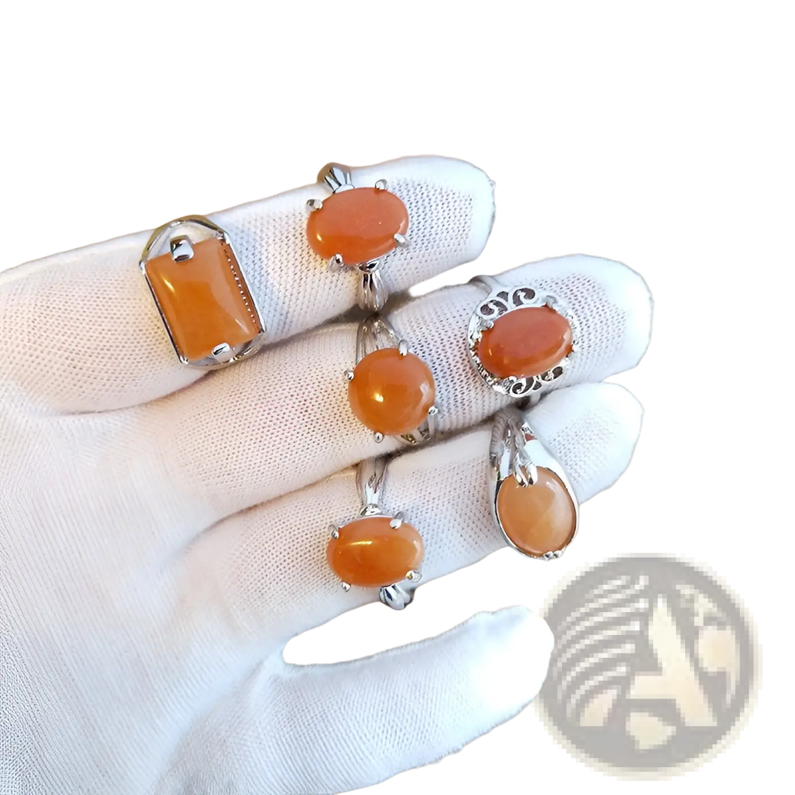 A collection of natural gemstone silver tone statement rings with orange carnelian stones in oval and rectangular cuts