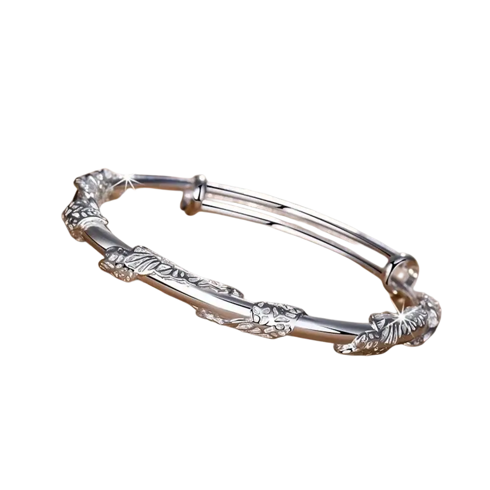 Silver adjustable bangle bracelet with intricate leaf and floral engravings featuring natural jade raw stone accents
