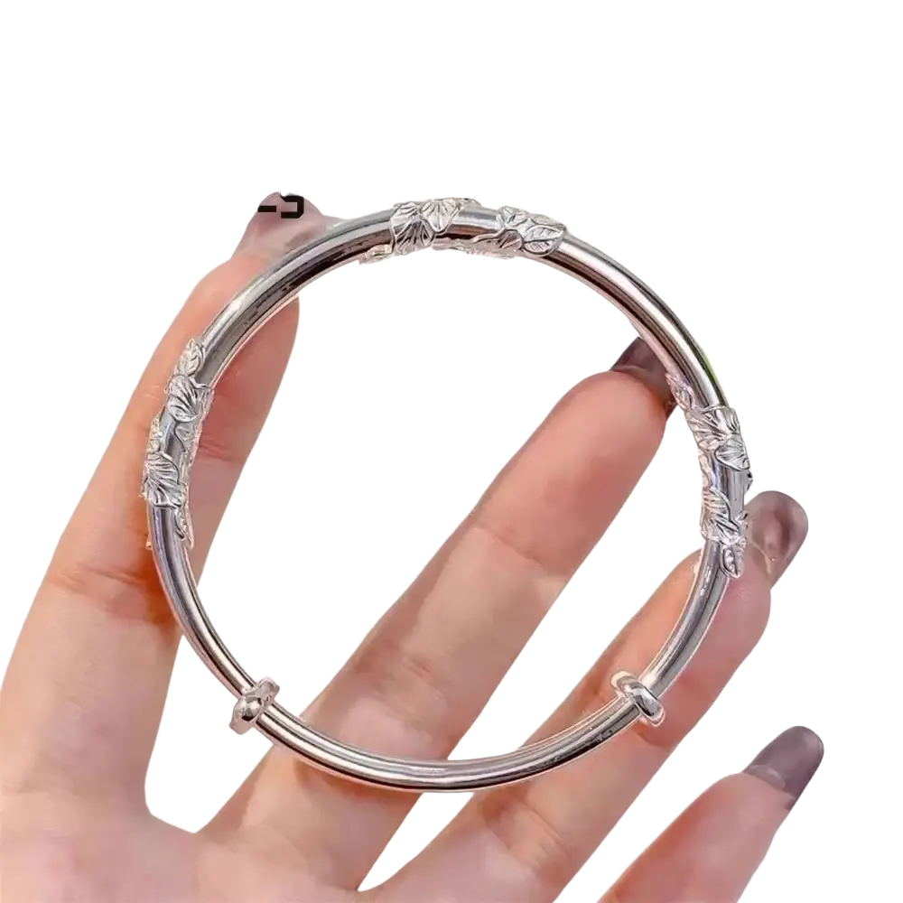 Natural jade raw floral sliding bangle with silver leaf-patterned design and adjustable clasp in polished finish
