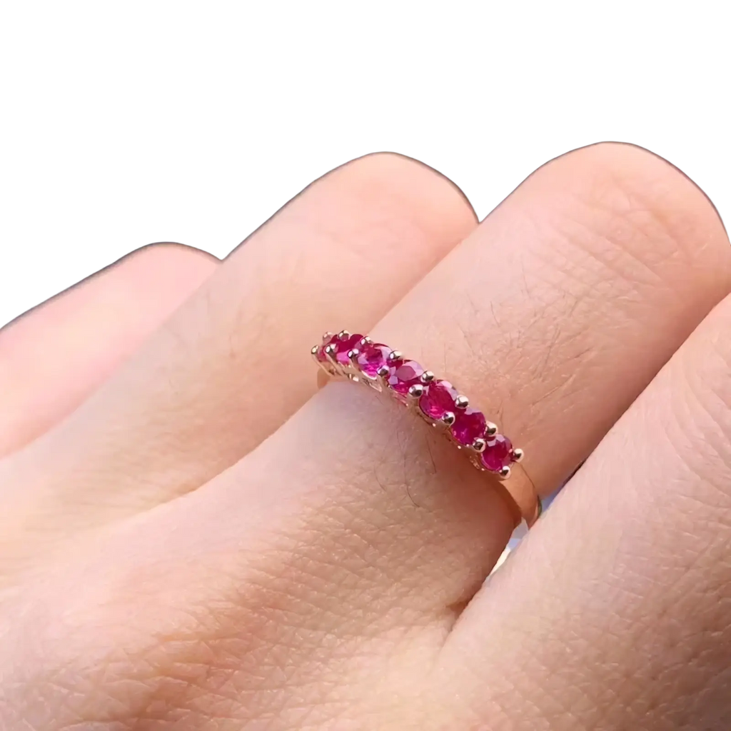 A delicate natural ruby silver ring band with a rose gold finish featuring a row of vibrant red rubies