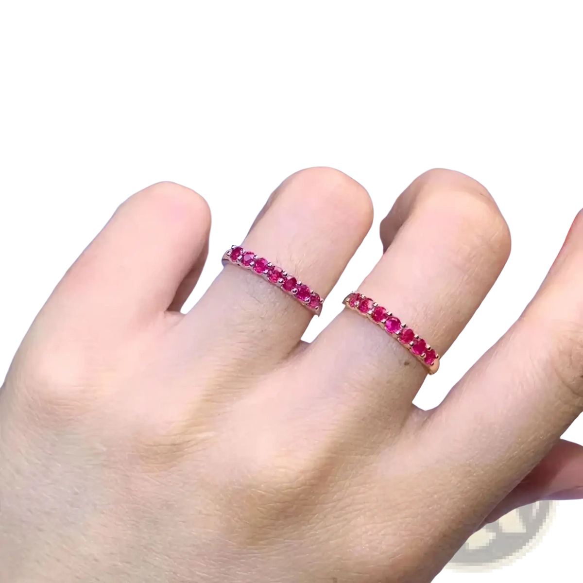 A pair of elegant rose gold natural ruby silver ring bands with continuous vibrant red rubies in a sleek design