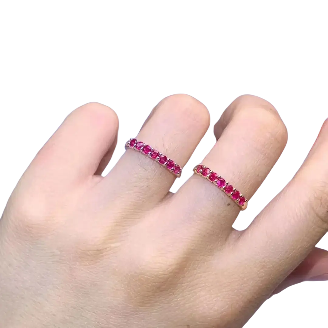 A pair of elegant natural ruby silver ring bands with vibrant red gemstones on delicate rose gold bands