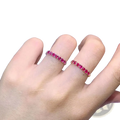 A pair of elegant natural ruby silver ring bands with vibrant red gemstones on delicate rose gold bands