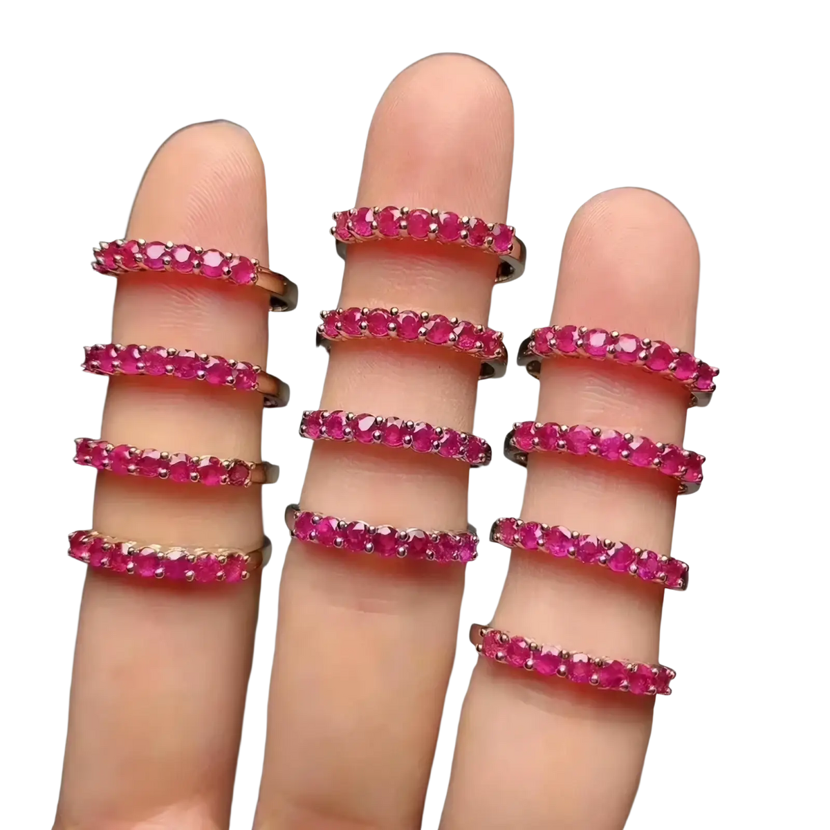 A set of nine stacked natural ruby silver ring bands with vibrant pink gemstones in sleek rose gold metal