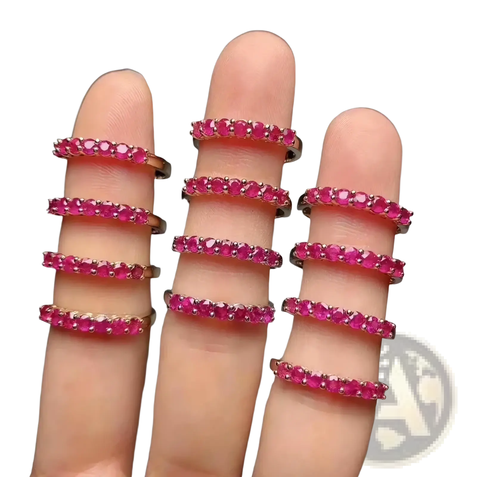 A set of nine stacked natural ruby silver ring bands with vibrant pink gemstones in sleek rose gold metal