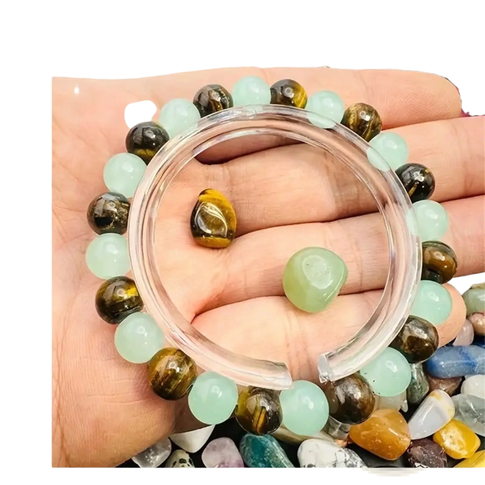 A hand holds a natural tiger eye and green aventurine beaded bracelet with alternating light green jade and tiger eye stones