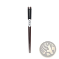 Dark brown natural wood chopsticks with black textured grips and a white label featuring Chinese characters