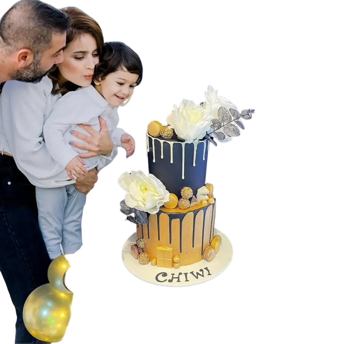 A two-tiered birthday cake with black and gold drip icing and floral silver and gold truffle decorations