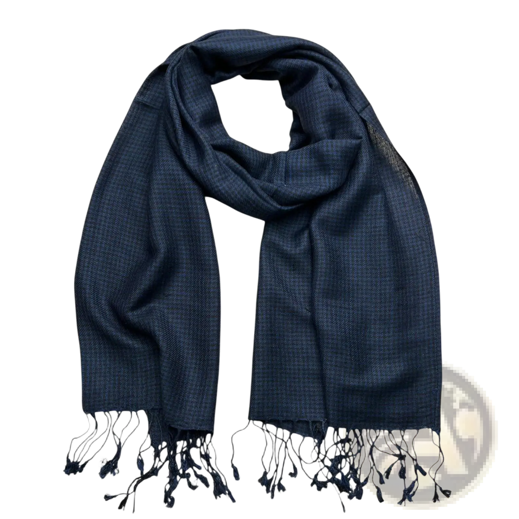 A navy jacquard herringbone scarf woven in navy blue with delicate black tassels at the ends