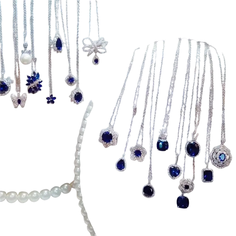 A collection of elegant silver necklace pendants with created sapphire stones and clear crystal accents in floral and butterfly designs