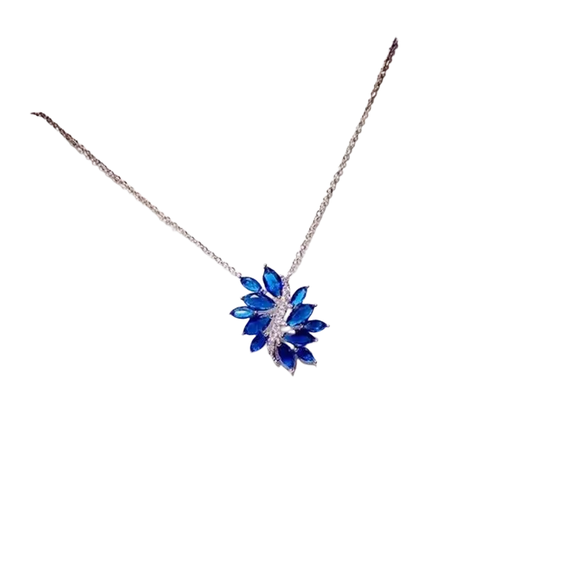 A delicate silver chain necklace pendant with a vibrant blue leaf-shaped created sapphire in fine jewelry