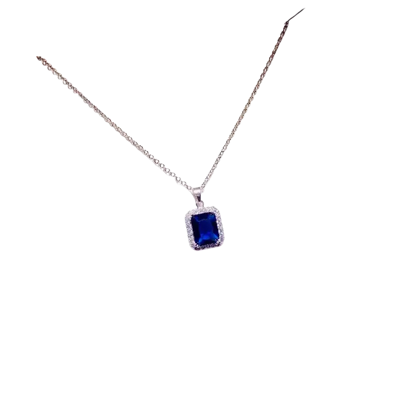 A delicate silver chain necklace pendant with a rectangular blue created sapphire surrounded by clear stones fine jewelry