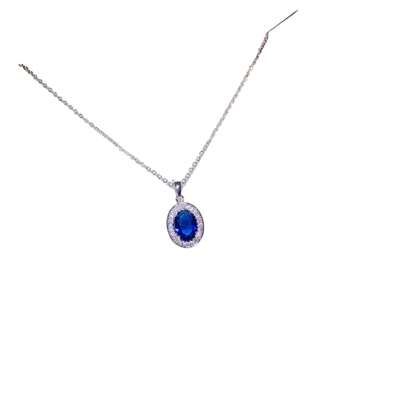 A delicate silver necklace pendant featuring an oval blue created sapphire surrounded by clear stones fine jewelry