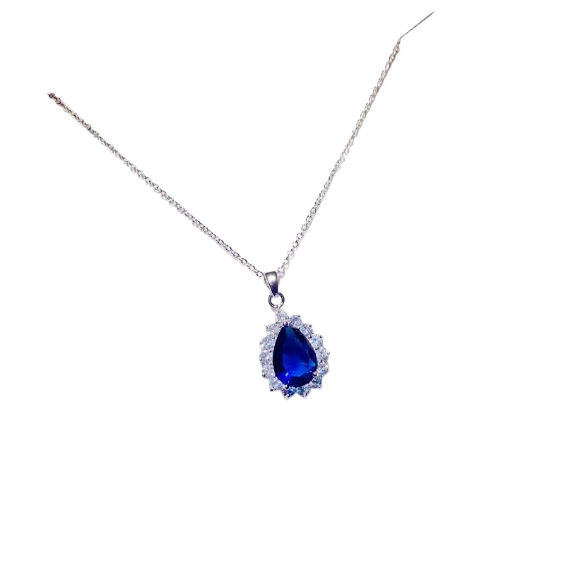 A delicate silver chain necklace pendant with a teardrop created sapphire surrounded by clear crystals fine jewelry